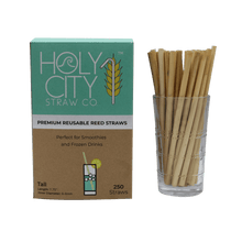 Load image into Gallery viewer, 250 count box of Holy City Straw Company Tall Reed Straws next to a cup of straws
