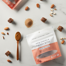Load image into Gallery viewer, Almond Chai Energy Bites on marble; almonds scattered about.