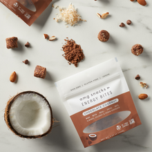 Load image into Gallery viewer, Chocolate Coconut Energy Bites on marble; almonds, choc, coconut pieces.
