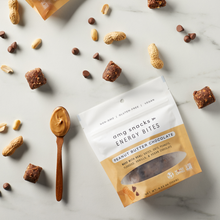 Load image into Gallery viewer, Peanut Butter Chocolate Energy Bites on marble; peanuts, chocolate chips.