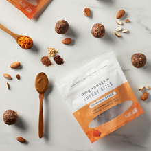 Load image into Gallery viewer, Pumpkin Spice Energy Bites, with almonds, and pumpkin puree on marble background.
