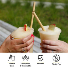 Load image into Gallery viewer, Two hands clinking frozen cocktails in plastic cups, each drink garnished with a fruit slice and served with a bamboo straw. Icons along the bottom read ‘Farm to Glass,’ ‘Sustainable & Renewable,’ ‘Durable,’ and ‘Plastic Free.