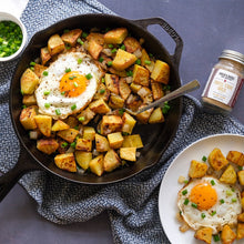 Load image into Gallery viewer, Skillet with potato hash and fried egg with purple stripe garlic from Burlap & Barrel