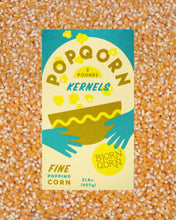 Load image into Gallery viewer, Box of Popqorn kernel on a popcorn kernel background