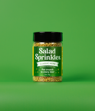 Load image into Gallery viewer, A bottle of Classic Herb SaladSprinkles on a green background