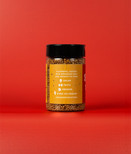 Load image into Gallery viewer, A side view of a bottle of Chili Crisp SaladSprinkles showing ways to use the product. The label states flavorful, puffed rice sprinkles that add crunch to your salad, pasta, veggies, even ice cream! #NoMoreCroutons