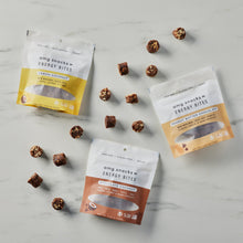 Load image into Gallery viewer, Chocolate Coconut, Peanut Butter Chocolate, and Chocolate Coconut Energy Bites on marble with energy bites scattered.