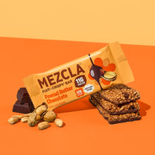 Load image into Gallery viewer, MEZCLA Puff-Crispy Bar in Peanut Butter Chocolate flavor with 11g protein and 170 calories, shown with scattered peanuts and stacked bars on orange background