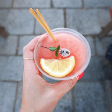 Load image into Gallery viewer, hand holding iced lemonade with cocktail wheat straw