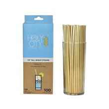 Load image into Gallery viewer, Holy City Straw Co. package of 100 tall wheat straws, suitable for hot and cold drinks, displayed next to a glass filled with the straws