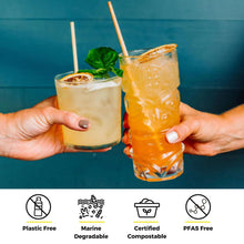 Load image into Gallery viewer, two hands cheersing tropical and citrus cocktail with wheat straw