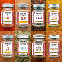 Load image into Gallery viewer, Collection of Burlap &amp; Barrel spice jars with labels on a textured orange background
