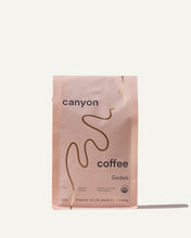 Load image into Gallery viewer, A bag of Gedeb Whole Bean coffee by Canyon Coffee with gold foil
