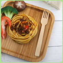 Load image into Gallery viewer, Holy City Straw Co. unwrapped bamboo fork next to plate of pasta
