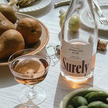 Load image into Gallery viewer, Non-alcoholic Sparkling Rosé Surely Glass on Table
