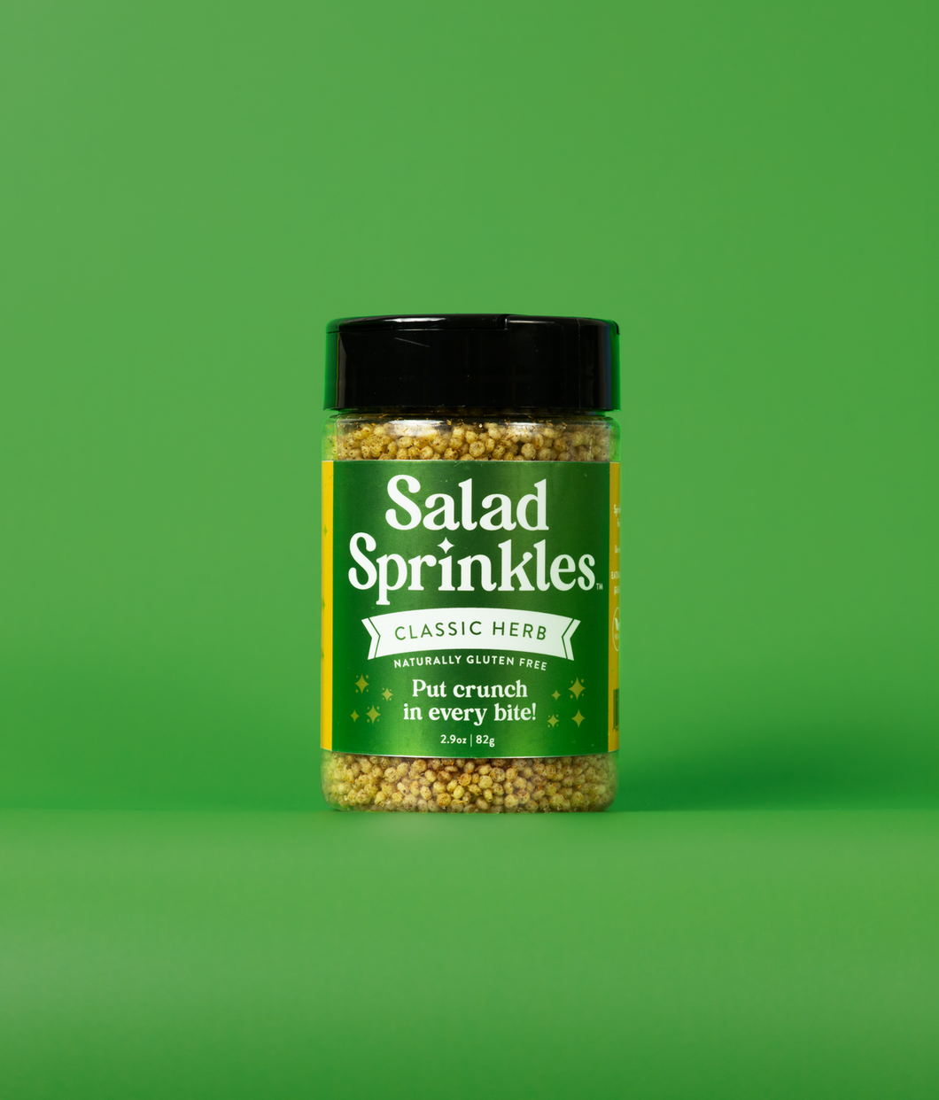 A bottle of Classic Herb SaladSprinkles on a green background