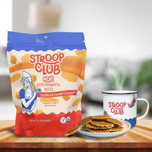Load image into Gallery viewer, Photo of a bag of mini stroopwafels, the stroopwafels itself next to it and the stroop club mug.
