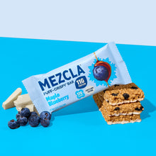 Load image into Gallery viewer, MEZCLA Maple Blueberry puff-crispy protein bar package with 11g protein and 170 calories, displayed with fresh blueberries and white chocolate pieces on blue background
