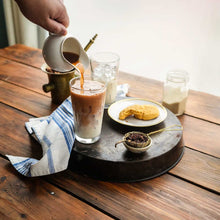 Load image into Gallery viewer, Image of Honeybush Chai concentrate being poured into milk.
