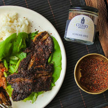 Load image into Gallery viewer, Korean BBQ short ribs with rice and lettuce next to a jar of Korean BBQ seasoning
