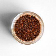 Load image into Gallery viewer, Curio Spice Co. fair-trade single origin sustainable Massachusetts ground chipotle chilies in a glass jar from above.
