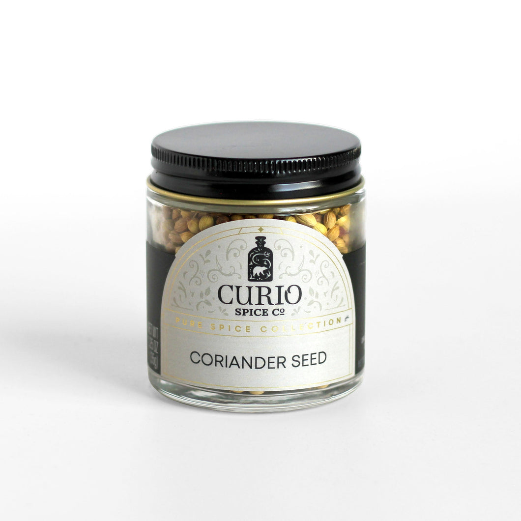 Curio Spice Co. fair-trade single origin sustainable coriander seeds in a glass jar.