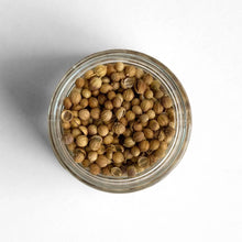 Load image into Gallery viewer, Curio Spice Co. fair-trade single origin sustainable coriander seeds in a glass jar from above.
