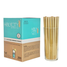 Load image into Gallery viewer, Right side view of Holy City Straw Co. box of 250 7.9-inch jumbo reed drinking straws, showcasing the company&#39;s story and eco-friendly practices, alongside a glass containing the straws.&quot;
