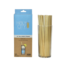 Load image into Gallery viewer, Holy City Straw Co. package of 100 tall wheat straws, suitable for hot and cold drinks, displayed next to a glass filled with the straws
