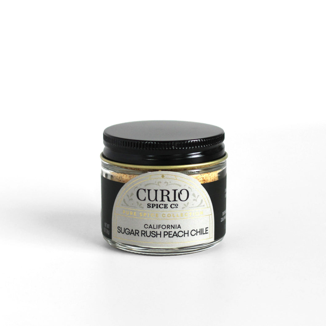 Curio Spice Co. fair-trade single origin sustainable California ground Sugar Rush Peach chile in a glass jar.