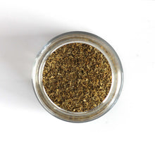 Load image into Gallery viewer, Curio Spice Co. fair-trade single origin sustainable ground coriander seeds in a glass jar from above.
