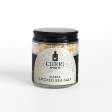 Load image into Gallery viewer, Curio Spice Co. fair-trade single origin sustainable Alaska Alderwood Smoked Sea Salt in a glass jar.
